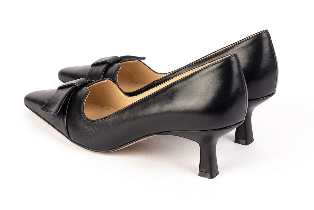 Women's black bow pumps with almond toe and mid spool heel - Rear view